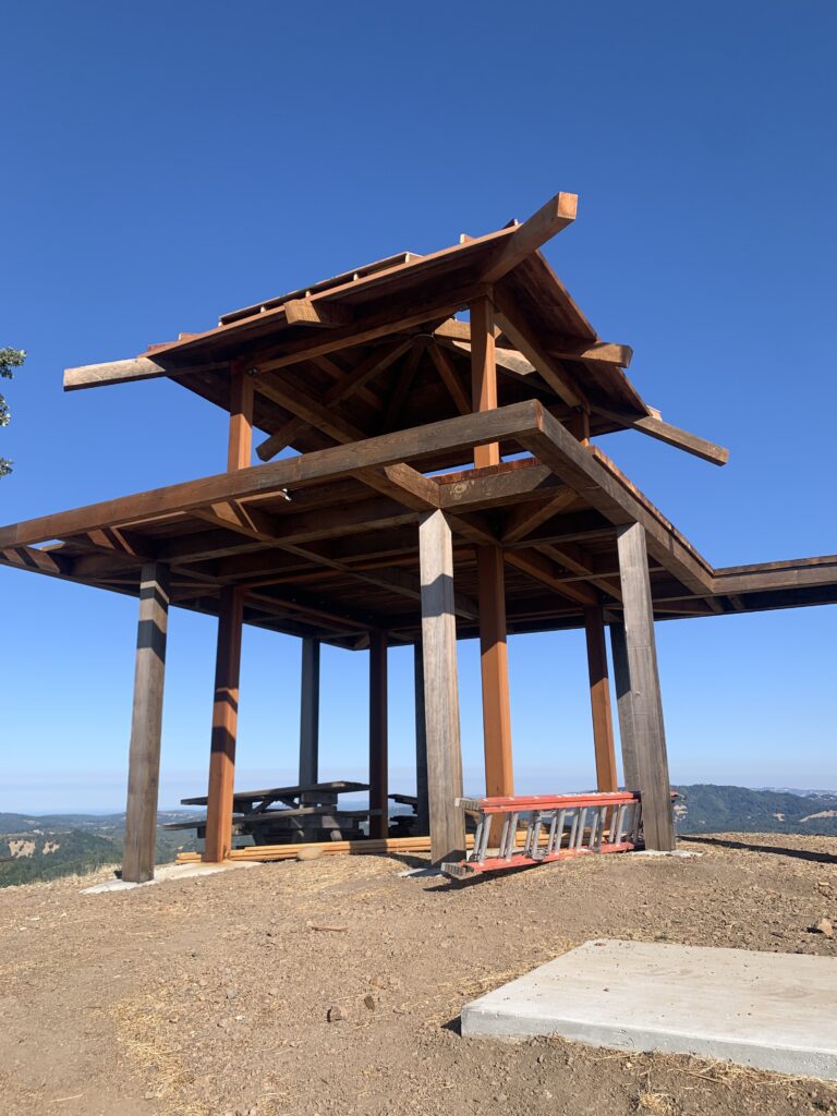 This is an image of the new Pole Mountain Lookout tower, showing the metal structure, wood decking, and roof of the build-in-progress.